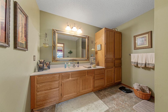 2200 15 1/2 St NW, Faribault, MN 55021 - bathroom featuring vanity, a textured ceiling, and baseboards