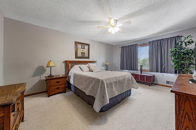 2200 15 1/2 St NW, Faribault, MN 55021 - bedroom with light carpet, a textured ceiling, ceiling fan, and baseboards