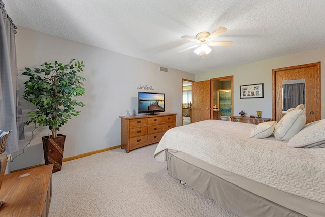2200 15 1/2 St NW, Faribault, MN 55021 - bedroom featuring light colored carpet, baseboards, a textured ceiling, ceiling fan, and connected bathroom