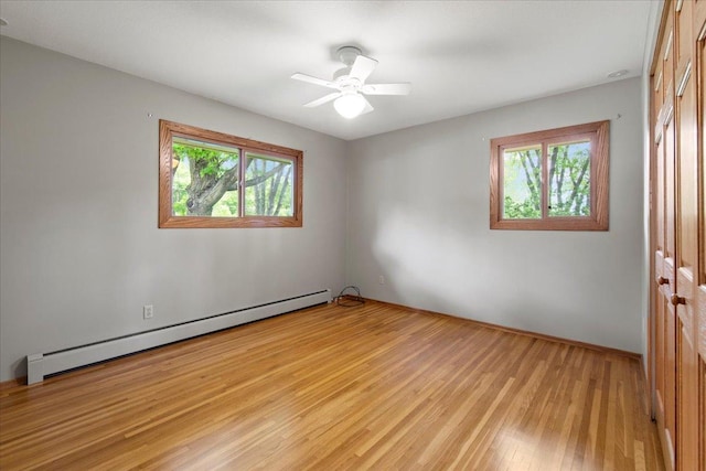 5935 County Road 11, Independence, MN 55359 - empty room featuring a baseboard radiator, light wood-type flooring, and a ceiling fan
