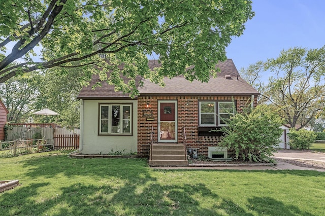 view of front of property featuring roof with shingles and brick siding