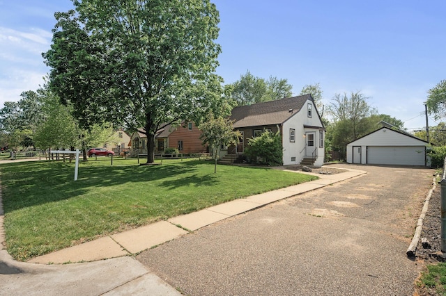 view of front facade with a detached garage, an outbuilding, entry steps, and a shingled roof