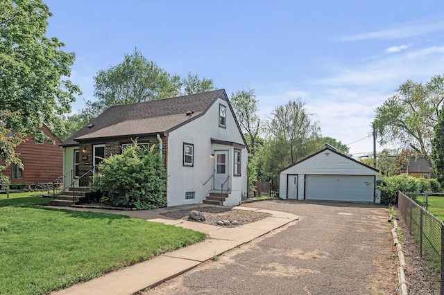 view of front of house featuring entry steps, a garage, an outdoor structure, stucco siding, and a shingled roof