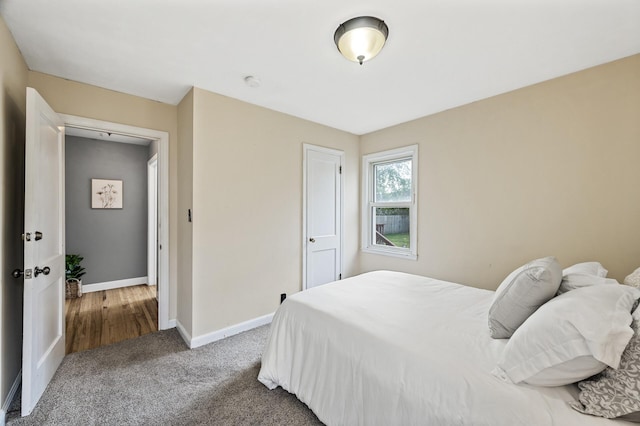 carpeted bedroom featuring baseboards and a closet