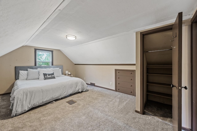 bedroom with carpet flooring, baseboards, lofted ceiling, and a textured ceiling