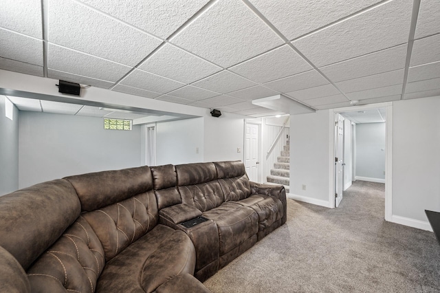 living room featuring stairs, carpet, baseboards, and a paneled ceiling