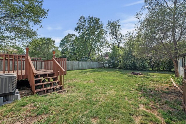 view of yard with a wooden deck, central AC unit, and stairs