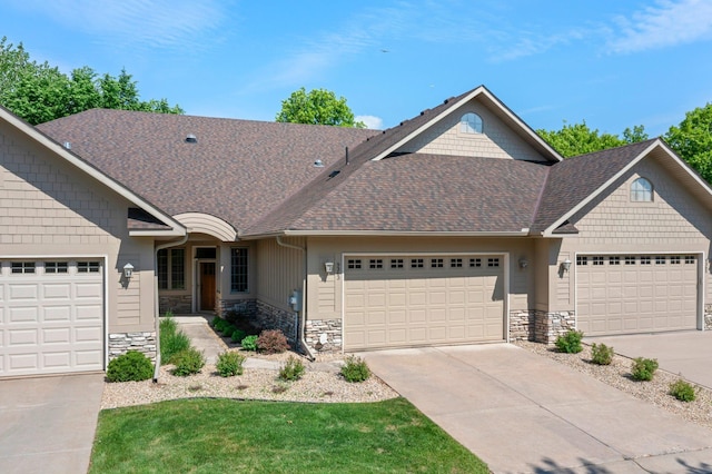 9363 Libby Ln, Eden Prairie, MN 55347 - craftsman house with stone siding, a garage, and concrete driveway