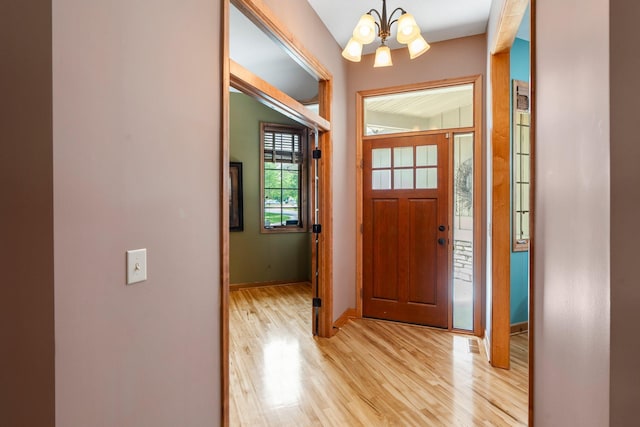 9363 Libby Ln, Eden Prairie, MN 55347 - entrance foyer with a chandelier, light wood finished floors, and baseboards