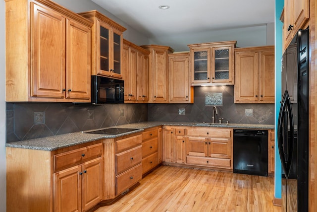 9363 Libby Ln, Eden Prairie, MN 55347 - kitchen with black appliances, a sink, light wood-style flooring, and dark stone countertops