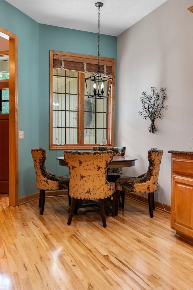9363 Libby Ln, Eden Prairie, MN 55347 - dining space featuring light wood-style floors, a chandelier, and baseboards