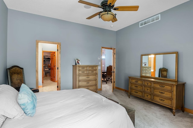 9363 Libby Ln, Eden Prairie, MN 55347 - bedroom featuring light colored carpet, baseboards, ceiling fan, and a walk in closet