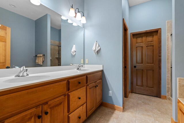 9363 Libby Ln, Eden Prairie, MN 55347 - full bathroom with double vanity, a shower stall, tile patterned flooring, and baseboards