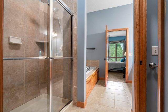 9363 Libby Ln, Eden Prairie, MN 55347 - ensuite bathroom featuring tile patterned floors, a garden tub, a shower stall, and baseboards