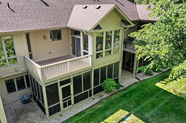 9363 Libby Ln, Eden Prairie, MN 55347 - rear view of property featuring a sunroom, roof with shingles, cooling unit, and a lawn