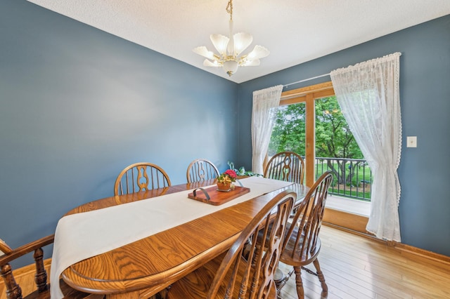 5155 Allen Dr, Woodbury, MN 55129 - dining space with a chandelier, wood-type flooring, and baseboards