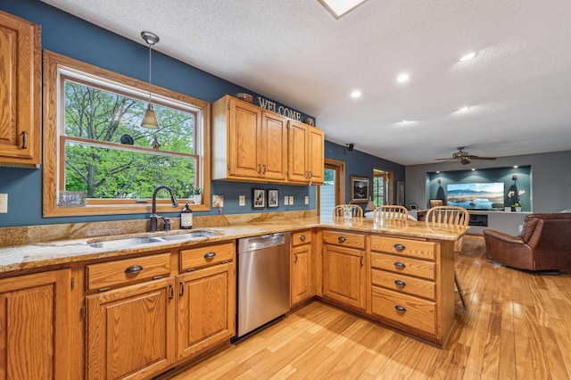 5155 Allen Dr, Woodbury, MN 55129 - kitchen featuring stainless steel dishwasher, a sink, a peninsula, light wood-style floors, and a textured ceiling