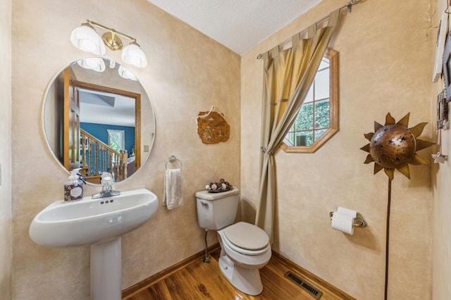 5155 Allen Dr, Woodbury, MN 55129 - half bathroom with wood finished floors, toilet, and baseboards