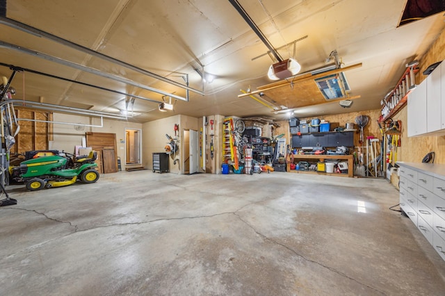 5155 Allen Dr, Woodbury, MN 55129 - garage featuring a garage door opener and a workshop area