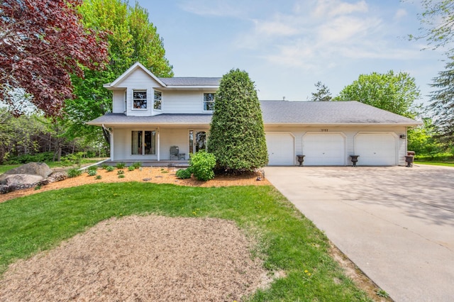 5155 Allen Dr, Woodbury, MN 55129 - view of front facade with driveway, covered porch, a front lawn, a garage, and a shingled roof