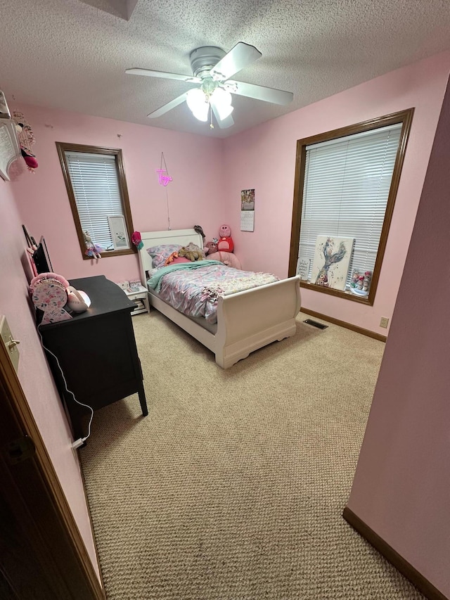 309 Oconnor St, Lakefield, MN 56150 - bedroom featuring light colored carpet, a textured ceiling, and a ceiling fan