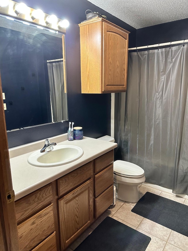 309 Oconnor St, Lakefield, MN 56150 - full bathroom featuring tile patterned flooring, toilet, vanity, a shower with curtain, and a textured ceiling