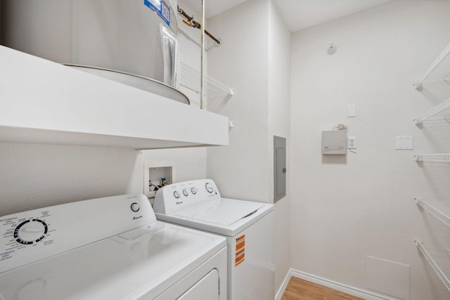 13560 Technology Dr Unit 1207, Eden Prairie, MN 55344 - washroom featuring washing machine and dryer, light wood finished floors, and baseboards