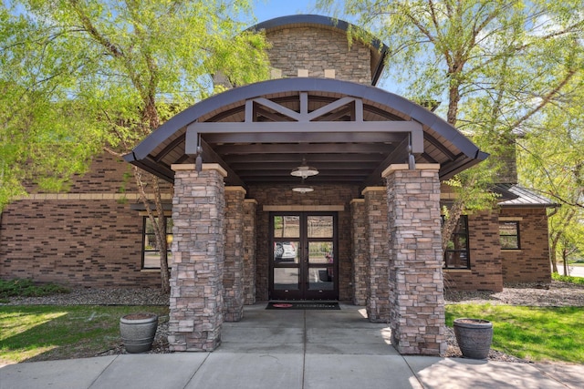 13560 Technology Dr Unit 1207, Eden Prairie, MN 55344 - property entrance featuring french doors, stone siding, a standing seam roof, and metal roof