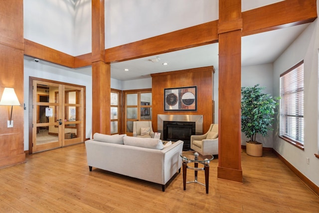 13560 Technology Dr Unit 1207, Eden Prairie, MN 55344 - living area with a fireplace, french doors, light wood-type flooring, decorative columns, and recessed lighting