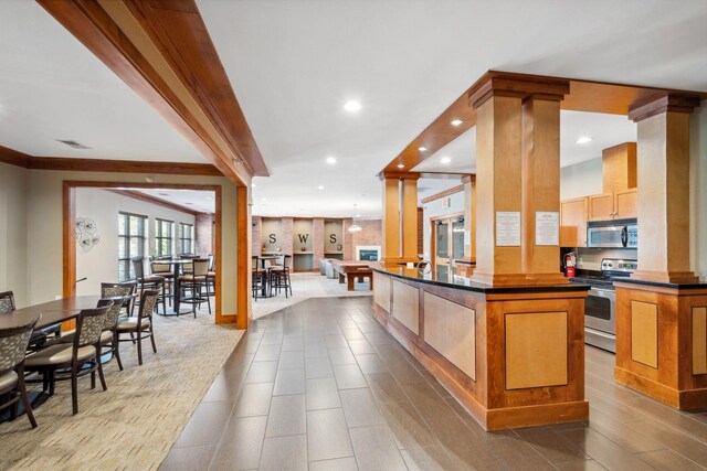 13560 Technology Dr Unit 1207, Eden Prairie, MN 55344 - kitchen with stainless steel appliances, dark countertops, decorative columns, recessed lighting, and open floor plan