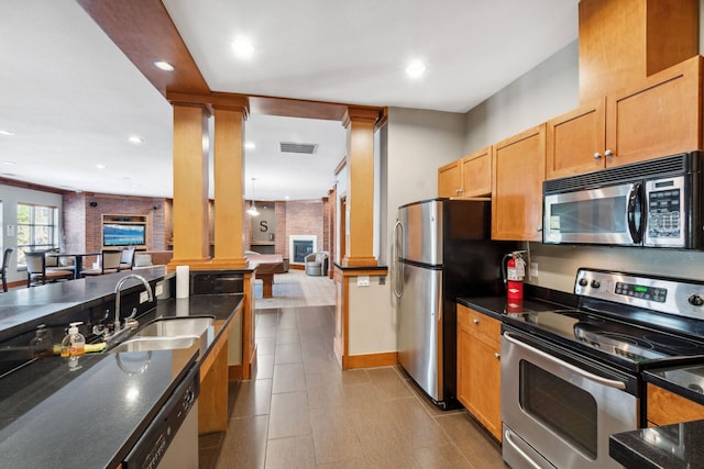 13560 Technology Dr Unit 1207, Eden Prairie, MN 55344 - kitchen featuring appliances with stainless steel finishes, open floor plan, a sink, decorative columns, and recessed lighting