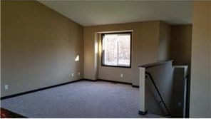 unfurnished living room featuring light carpet