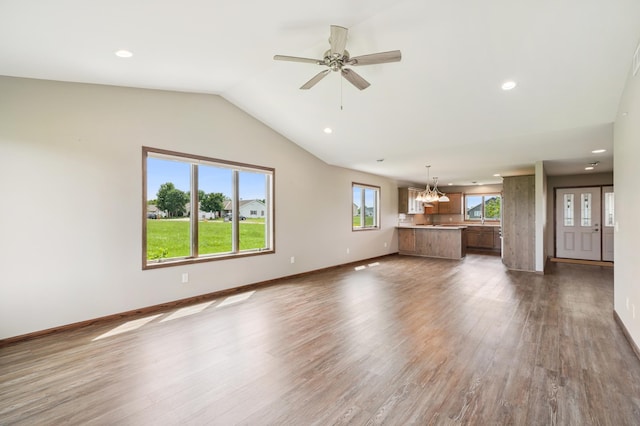 1516 Ranger Dr, Glencoe, MN 55336 - unfurnished living room with dark wood-style flooring, recessed lighting, vaulted ceiling, a ceiling fan, and a chandelier