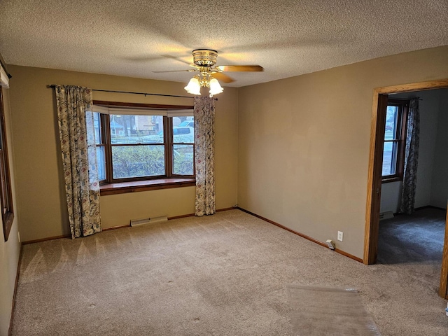 103 Bloomer St E, Morristown, MN 55052 - empty room with carpet flooring, ceiling fan, plenty of natural light, a textured ceiling, and baseboards