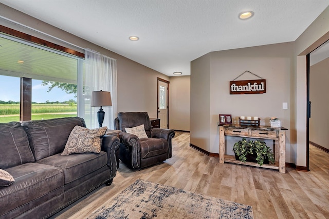 living room with baseboards, light wood-style floors, and recessed lighting