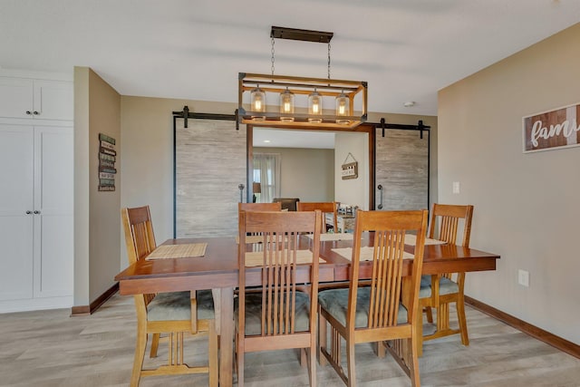 21048 Eagle Dr, Leslie Twp, MN 56360 - dining area with a barn door, baseboards, and light wood-style floors