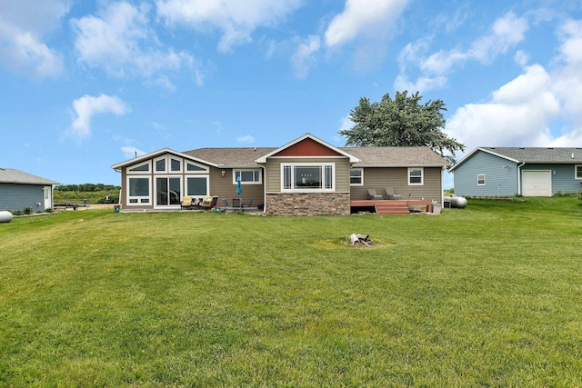 21048 Eagle Dr, Leslie Twp, MN 56360 - rear view of house with a yard, stone siding, and a shingled roof