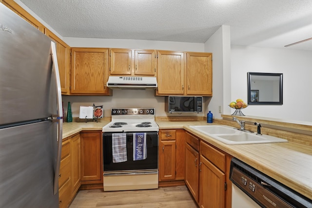 7625 Edinborough Way Unit 2116, Edina, MN 55435 - kitchen with white appliances, under cabinet range hood, a sink, light countertops, and a textured ceiling