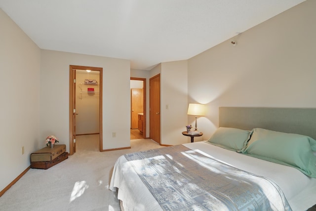 7625 Edinborough Way Unit 2116, Edina, MN 55435 - bedroom featuring light carpet, a walk in closet, baseboards, and a closet
