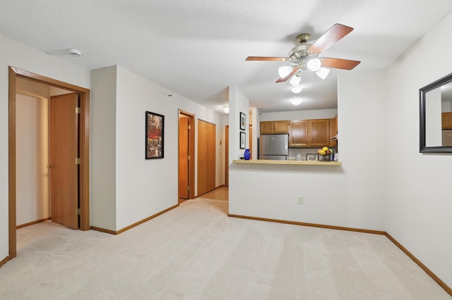 7625 Edinborough Way Unit 2116, Edina, MN 55435 - kitchen with freestanding refrigerator, light carpet, a ceiling fan, and brown cabinets