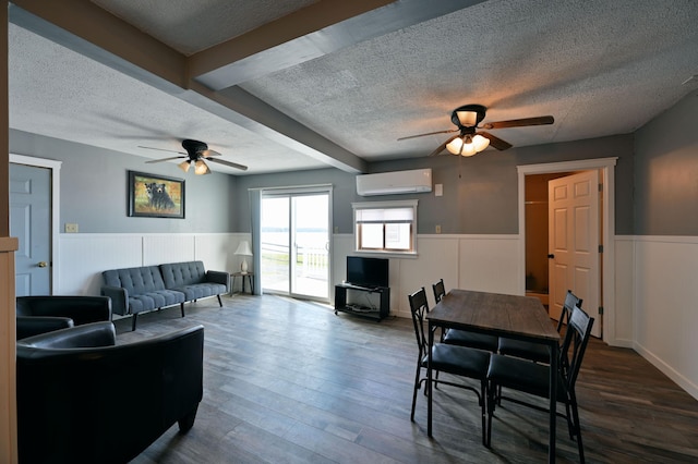 CABIN5 Gruenhagen Rd, Long Lake Twp, WI 54817 - living room featuring a ceiling fan, a textured ceiling, a wall mounted air conditioner, wainscoting, and dark wood finished floors