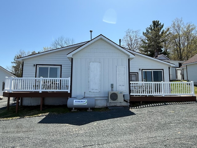 CABIN5 Gruenhagen Rd, Long Lake Twp, WI 54817 - rear view of property with a wooden deck, ac unit, and board and batten siding