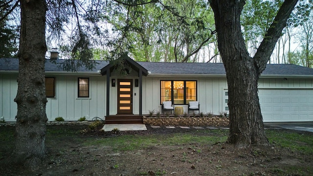 1795 Nolan Ave N, West Lakeland Twp, MN 55082 - view of front of home with a garage, a chimney, board and batten siding, and roof with shingles
