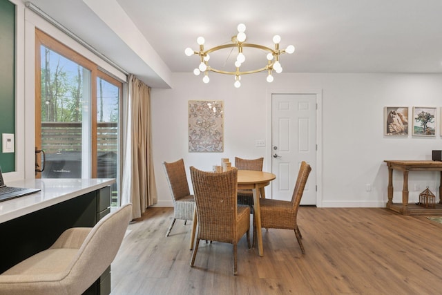1795 Nolan Ave N, West Lakeland Twp, MN 55082 - dining area with a chandelier, light wood finished floors, and baseboards