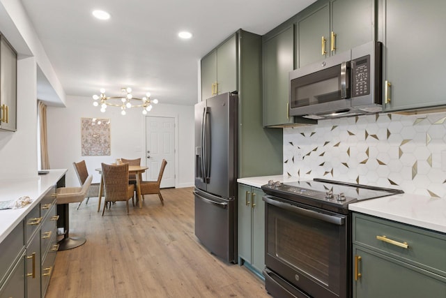 1795 Nolan Ave N, West Lakeland Twp, MN 55082 - kitchen featuring stainless steel appliances, green cabinetry, a chandelier, light countertops, and recessed lighting