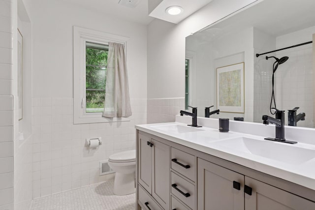 1795 Nolan Ave N, West Lakeland Twp, MN 55082 - full bathroom with toilet, double vanity, wainscoting, tile walls, and a shower