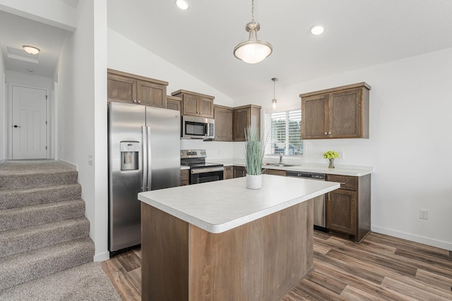 1129 Tiger Ct NE, Isanti, MN 55040 - kitchen with stainless steel appliances, light countertops, dark wood-type flooring, a sink, and vaulted ceiling