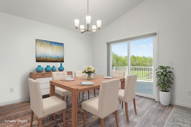 1129 Tiger Ct NE, Isanti, MN 55040 - dining area with a chandelier, light wood-style floors, baseboards, and vaulted ceiling