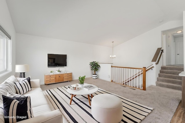 1129 Tiger Ct NE, Isanti, MN 55040 - living area with vaulted ceiling, a chandelier, carpet, and stairs