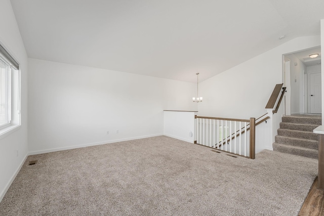 1129 Tiger Ct NE, Isanti, MN 55040 - spare room with vaulted ceiling, a chandelier, carpet flooring, and baseboards